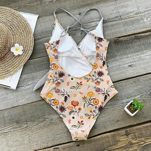 Maternity one-piece swimsuit with a wrap V-neck, featuring a mix of black and white stripes and a peach floral print. - Image 4