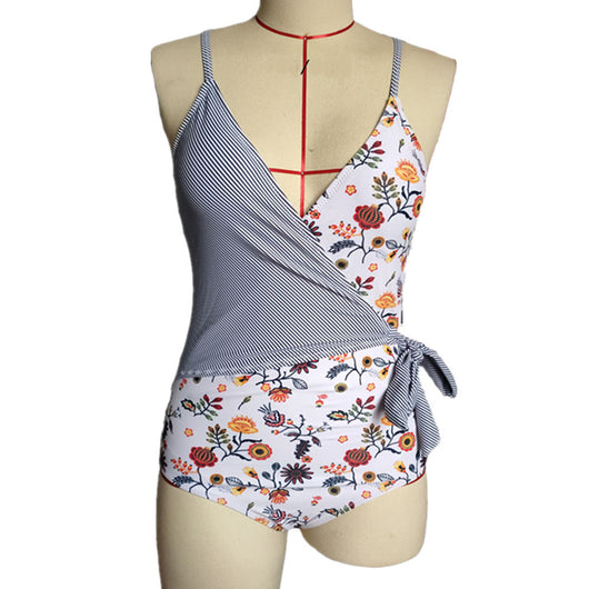 Maternity one-piece swimsuit with a wrap V-neck, featuring a mix of black and white stripes and a peach floral print. - Image 3
