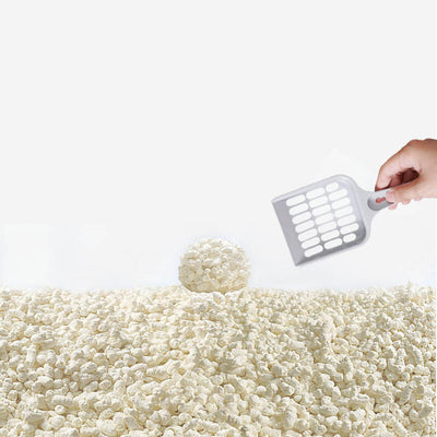 Close-up of a pile of light-colored, irregularly shaped tofu cat litter pellets in a wooden bowl. - Image 3