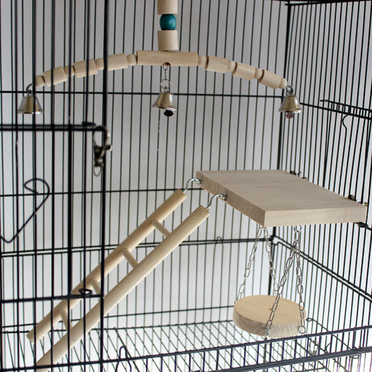 Wooden bird chew toy with a curved perch made of beads and cylinders, featuring three silver bells and a blue accent bead, hanging from a metal chain. - Image 4