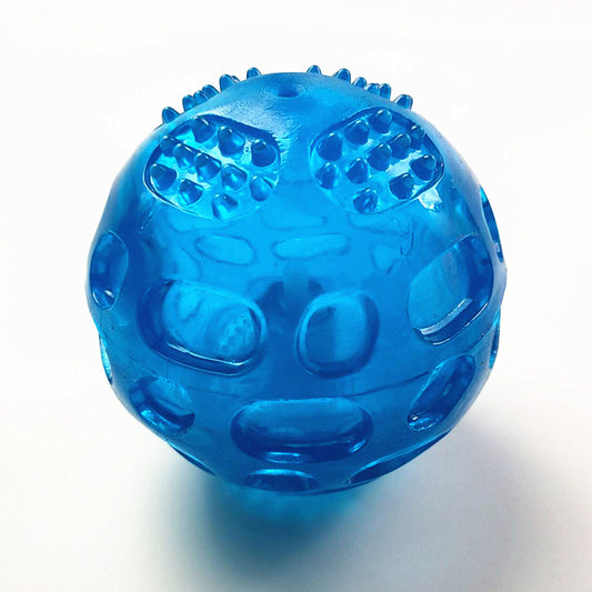 Translucent blue rubber dog toy ball with textured nubs and recessed areas for chewing and teeth cleaning.