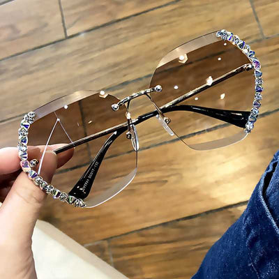 Women's rimless oversized sunglasses with gradient brown lenses and clear, purple, and blue rhinestone embellishments. - Image 22