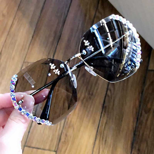 Women's rimless oversized sunglasses with gradient brown lenses and clear, purple, and blue rhinestone embellishments. - Image 10