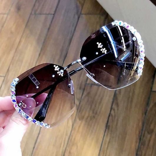 Women's rimless oversized sunglasses with gradient brown lenses and clear, purple, and blue rhinestone embellishments. - Image 2