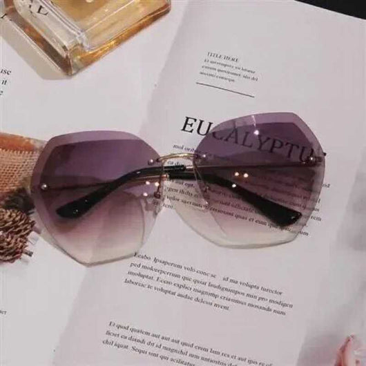 Women's rimless oversized sunglasses with gradient brown lenses and clear, purple, and blue rhinestone embellishments. - Image 5
