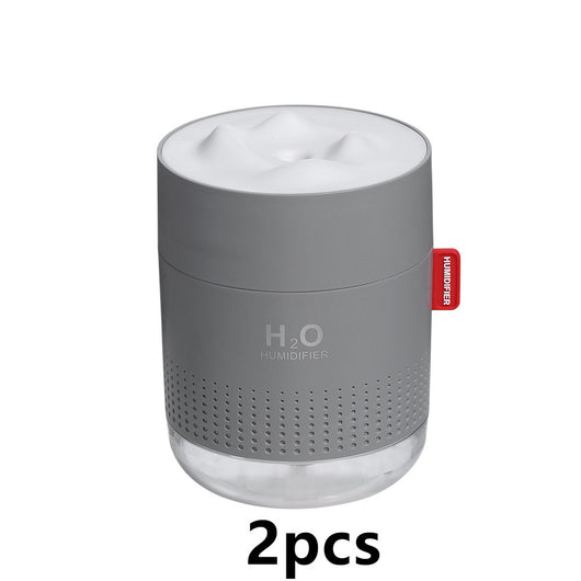 White cylindrical USB charging desktop humidifier with a clear base and a textured snow mountain top. Features 'H₂O HUMIDIFIER' text and a red tag. - Image 8