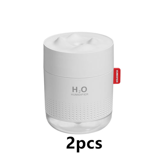 White cylindrical USB charging desktop humidifier with a clear base and a textured snow mountain top. Features 'H₂O HUMIDIFIER' text and a red tag. - Image 9