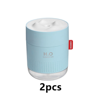 White cylindrical USB charging desktop humidifier with a clear base and a textured snow mountain top. Features 'H₂O HUMIDIFIER' text and a red tag. - Image 11
