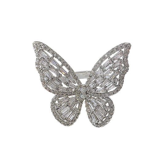 Sparkling silver-tone butterfly ring with clear baguette and round cut stones on a white surface. - Image 6