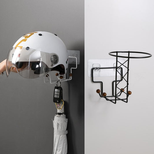 White punch-free wall-mounted storage rack with hooks, holding a beige baseball cap, a handbag, and an umbrella on a light wood door.