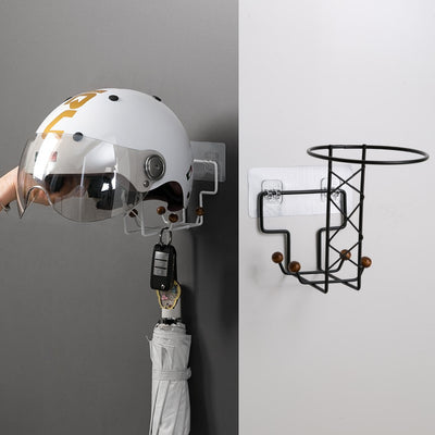 White punch-free wall-mounted storage rack with hooks, holding a beige baseball cap, a handbag, and an umbrella on a light wood door.
