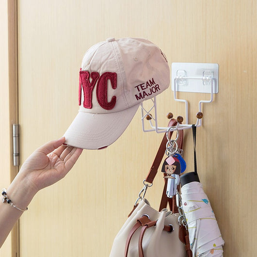 White punch-free wall-mounted storage rack with hooks, holding a beige baseball cap, a handbag, and an umbrella on a light wood door. - Image 4