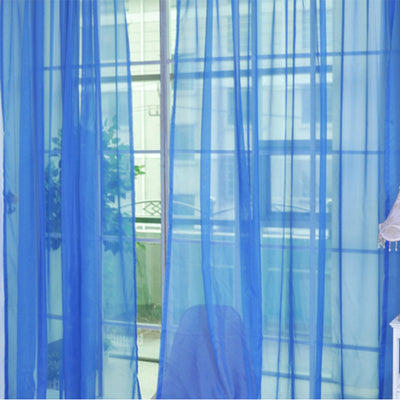 Close-up of a solid red sheer tulle curtain hanging in front of a window, allowing light to filter through. - Image 3
