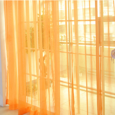 Close-up of a solid red sheer tulle curtain hanging in front of a window, allowing light to filter through. - Image 4