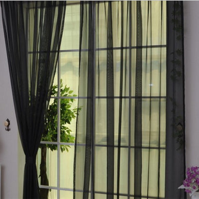 Close-up of a solid red sheer tulle curtain hanging in front of a window, allowing light to filter through. - Image 5