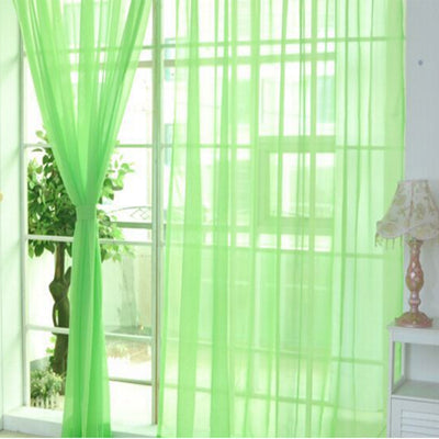 Close-up of a solid red sheer tulle curtain hanging in front of a window, allowing light to filter through. - Image 6