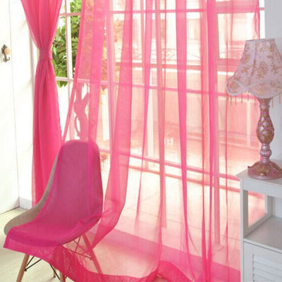 Close-up of a solid red sheer tulle curtain hanging in front of a window, allowing light to filter through. - Image 11