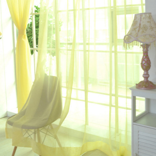 Close-up of a solid red sheer tulle curtain hanging in front of a window, allowing light to filter through. - Image 33