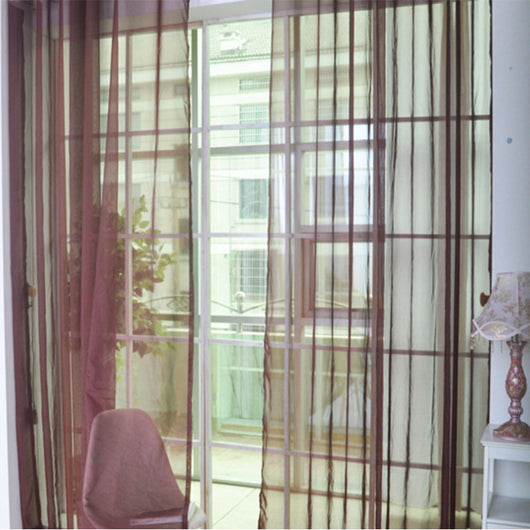 Close-up of a solid red sheer tulle curtain hanging in front of a window, allowing light to filter through. - Image 10