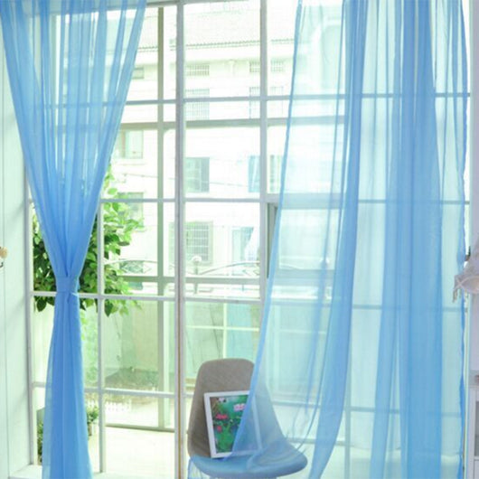 Close-up of a solid red sheer tulle curtain hanging in front of a window, allowing light to filter through. - Image 12