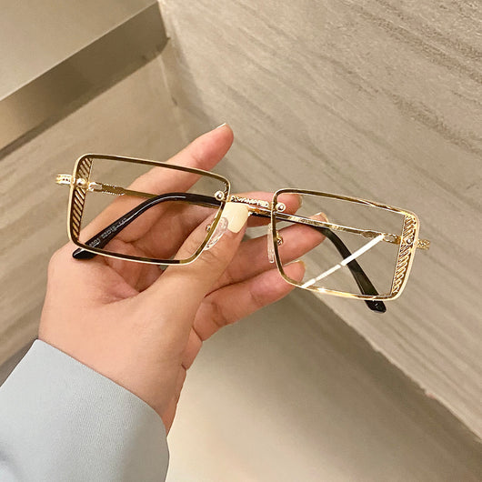 Retro small box red sunglasses with square resin lenses and gold-colored frames, held by a hand. - Image 13