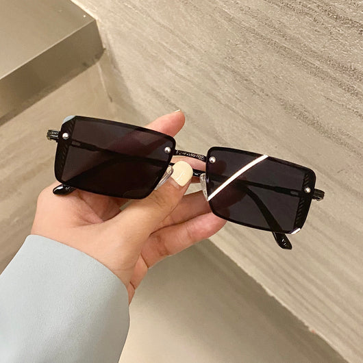 Retro small box red sunglasses with square resin lenses and gold-colored frames, held by a hand. - Image 14
