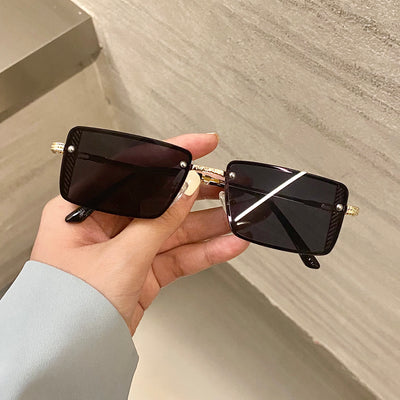 Retro small box red sunglasses with square resin lenses and gold-colored frames, held by a hand. - Image 3