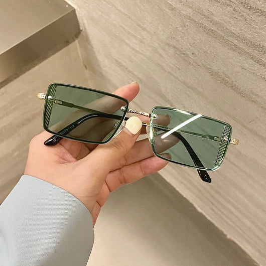 Retro small box red sunglasses with square resin lenses and gold-colored frames, held by a hand.