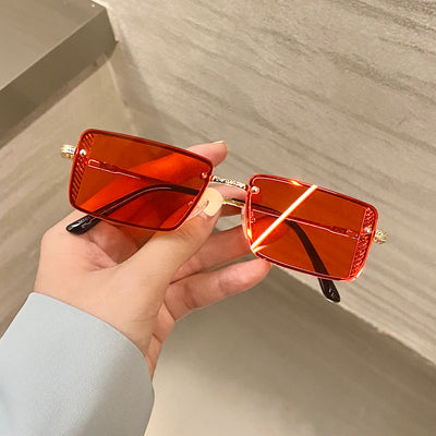 Retro small box red sunglasses with square resin lenses and gold-colored frames, held by a hand. - Image 4