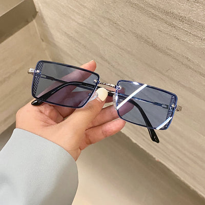 Retro small box red sunglasses with square resin lenses and gold-colored frames, held by a hand. - Image 6