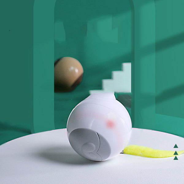 White LED luminous automatic cat rolling ball with a grey face design, yellow feather, and small bell.
