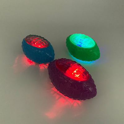 Green rubber pet toy shaped like a rugby ball with a translucent, faceted center for dogs. - Image 3