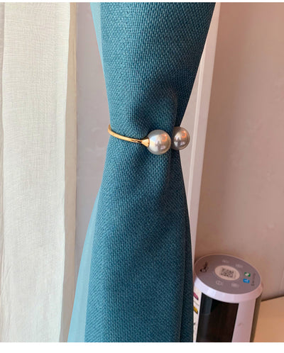 Gold alloy curtain tie-back with two large white faux pearls holding back a teal woven curtain. - Image 8
