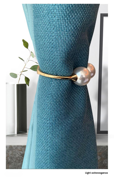 Gold alloy curtain tie-back with two large white faux pearls holding back a teal woven curtain. - Image 5