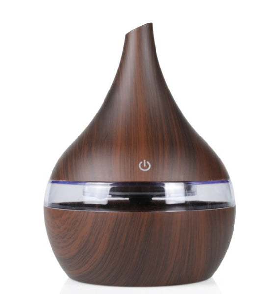Light wood grain teardrop-shaped mini humidifier and aroma diffuser with a clear water tank and power button. - Image 13