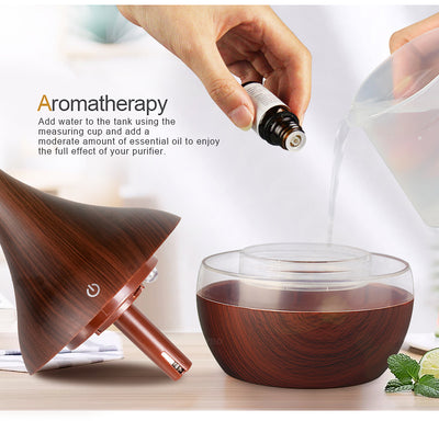 Light wood grain teardrop-shaped mini humidifier and aroma diffuser with a clear water tank and power button. - Image 3