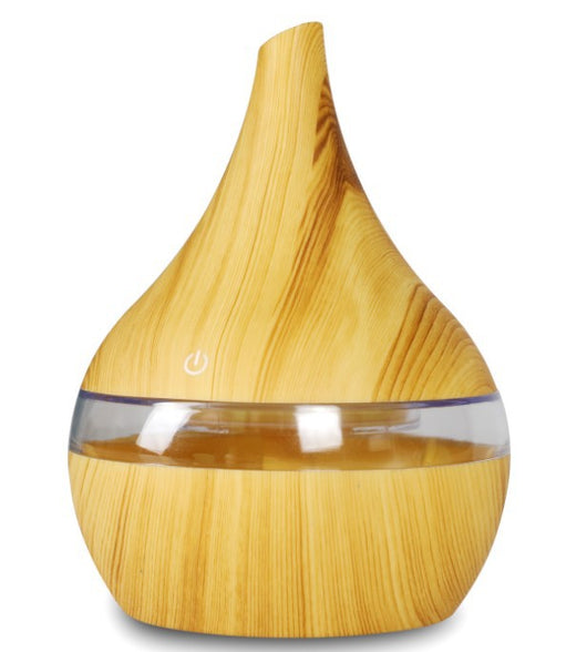 Light wood grain teardrop-shaped mini humidifier and aroma diffuser with a clear water tank and power button. - Image 6
