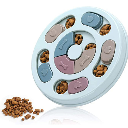 Light blue round dog puzzle feeding bowl with sliding covers in muted colors, filled with kibble.
