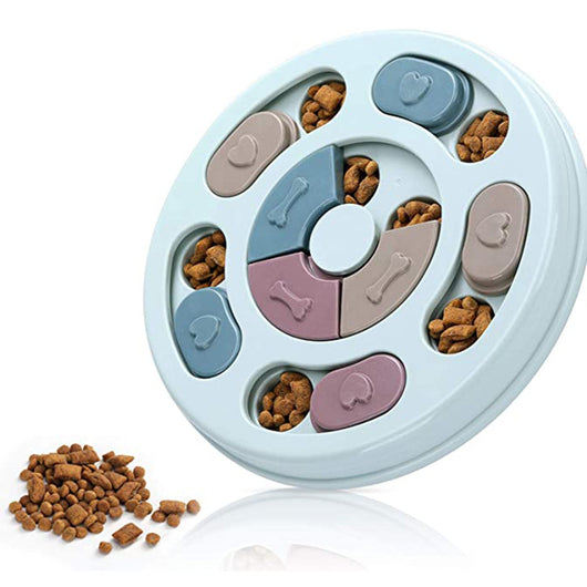 Light blue round dog puzzle feeding bowl with sliding covers in muted colors, filled with kibble.