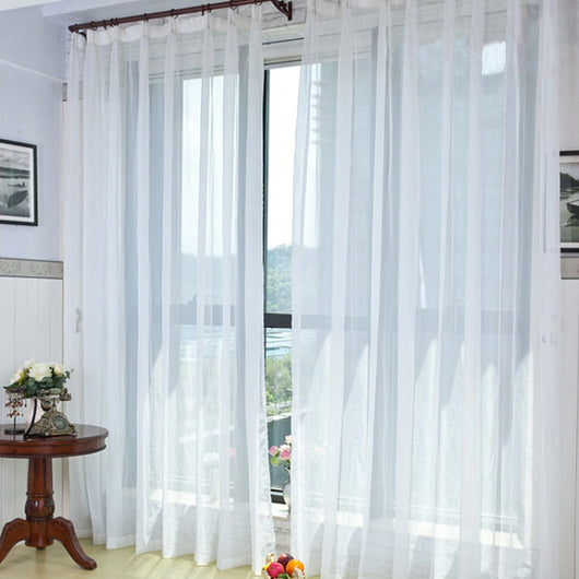 Light green sheer curtains hanging on a rod, one tied back, in a modern living room with white walls. - Image 12