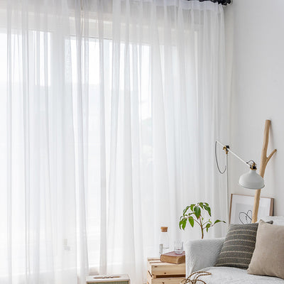 Light green sheer curtains hanging on a rod, one tied back, in a modern living room with white walls. - Image 9