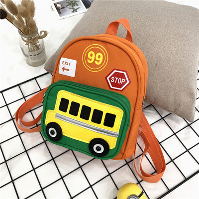 Green mini backpack for kids with a yellow school bus design on the front pocket, 'EXIT', '99', and 'STOP' patches. - Image 2