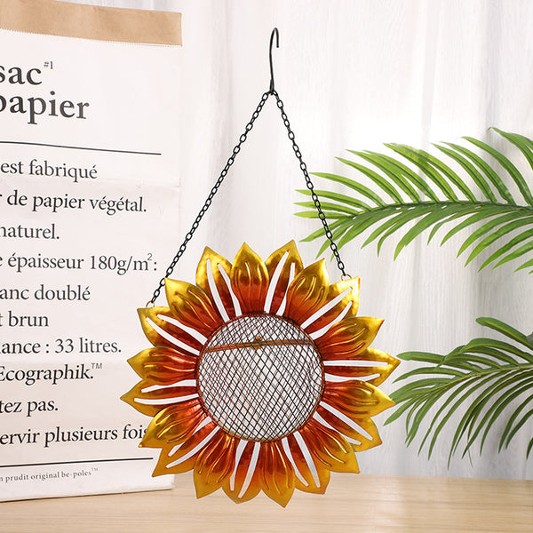Yellow and orange wrought iron flower-shaped bird feeder with a mesh seed tray and hanging chain.