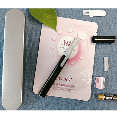Pink electric shaver with cap off, showing blade, comb attachment, cleaning brush, and AA battery on a pink sheet mask. - Image 6