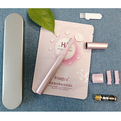 Pink electric shaver with cap off, showing blade, comb attachment, cleaning brush, and AA battery on a pink sheet mask. - Image 7