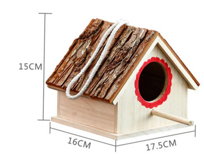Rustic wooden birdhouse with bark roof, red scalloped entrance, and a hanging rope on a white background. - Image 7