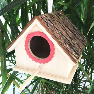 Rustic wooden birdhouse with bark roof, red scalloped entrance, and a hanging rope on a white background. - Image 11