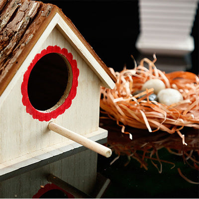 Rustic wooden birdhouse with bark roof, red scalloped entrance, and a hanging rope on a white background. - Image 4