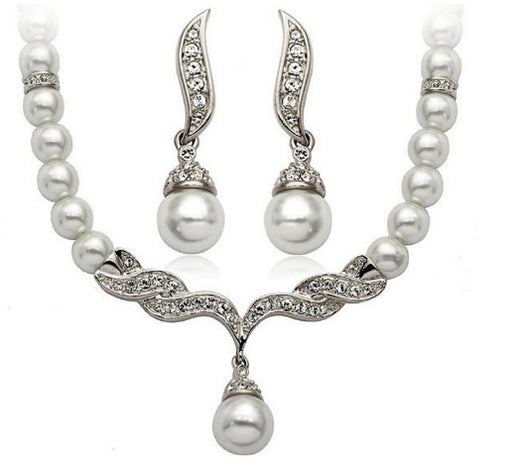 Elegant pearl necklace and matching drop earrings set with sparkling crystal accents, ideal for bridal wear. - Image 6