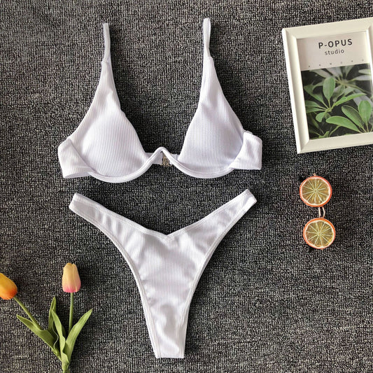 Neon green ribbed two-piece swimsuit with an underwire bikini top and high-cut bottoms on a dark grey background.